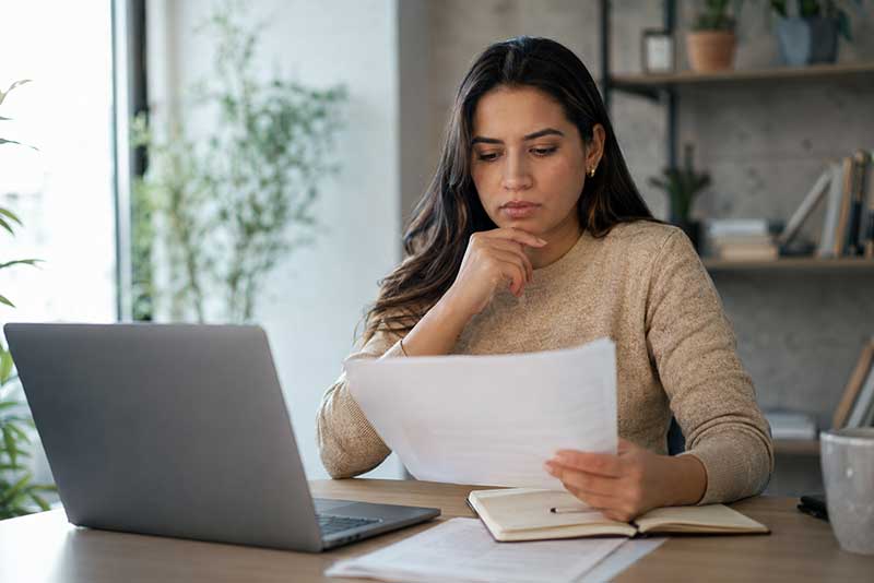 Venezuelan woman reviewing her documents and possible immigration options after TPS